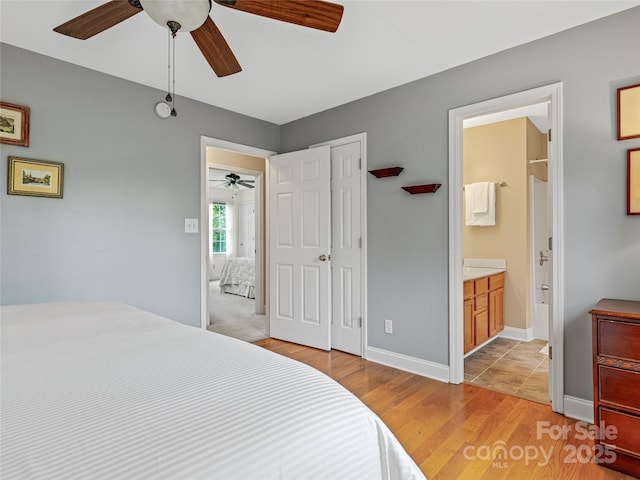 7 Mill Stone Dr, Asheville, NC 28803 - bedroom with light wood-style flooring, ceiling fan, and ensuite bath