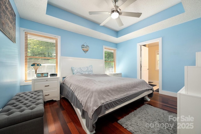 178 Susanna Cove Rd, Mars Hill, NC 28754 - bedroom featuring a raised ceiling, dark wood finished floors, a ceiling fan, and connected bathroom