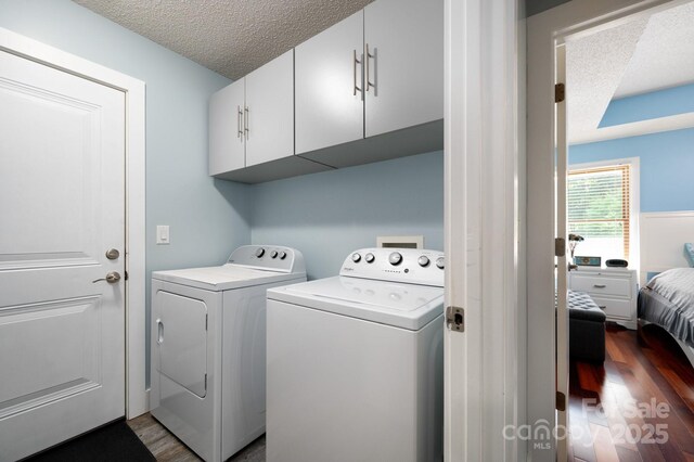178 Susanna Cove Rd, Mars Hill, NC 28754 - washroom featuring dark wood-type flooring, washer and dryer, cabinet space, and a textured ceiling