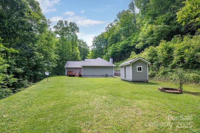 178 Susanna Cove Rd, Mars Hill, NC 28754 - view of grassy yard featuring a fire pit, a deck, and a storage unit