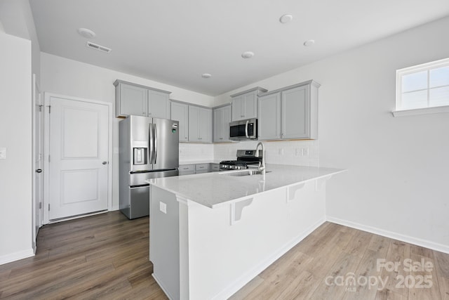 223 Haddonsfield Dr, Mooresville, NC 28115 - kitchen with stainless steel appliances, gray cabinets, a sink, and a peninsula