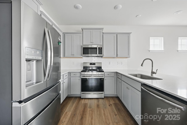 223 Haddonsfield Dr, Mooresville, NC 28115 - kitchen featuring stainless steel appliances, a sink, gray cabinetry, light countertops, and dark wood-style flooring