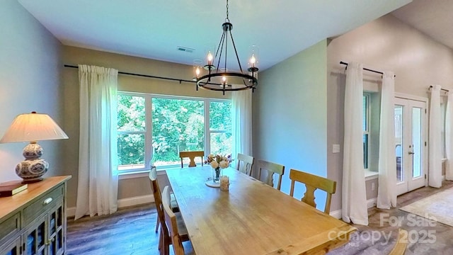 3633 Longpond Ln, Monroe, NC 28110 - dining area with a chandelier, wood finished floors, and baseboards