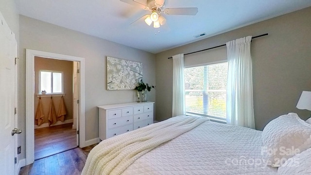 3633 Longpond Ln, Monroe, NC 28110 - bedroom with wood finished floors, baseboards, ceiling fan, and connected bathroom