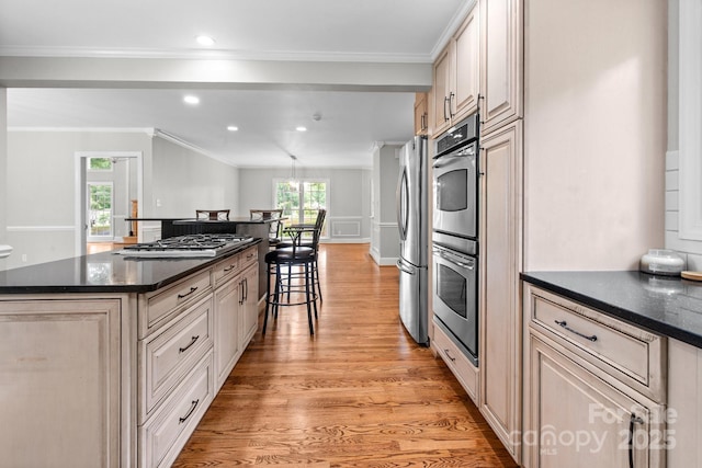 315 Red Barn Trl, Matthews, NC 28104 - kitchen with light wood-style flooring, healthy amount of natural light, appliances with stainless steel finishes, a center island, and ornamental molding