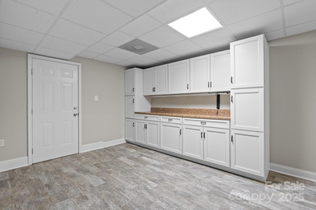 315 Red Barn Trl, Matthews, NC 28104 - kitchen featuring a drop ceiling, white cabinetry, and light wood-style flooring