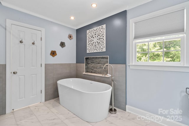 315 Red Barn Trl, Matthews, NC 28104 - bathroom featuring tile walls, a soaking tub, marble finish flooring, crown molding, and wainscoting