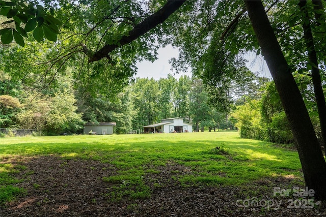 315 Red Barn Trl, Matthews, NC 28104 - view of grassy yard with an outbuilding and a forest view