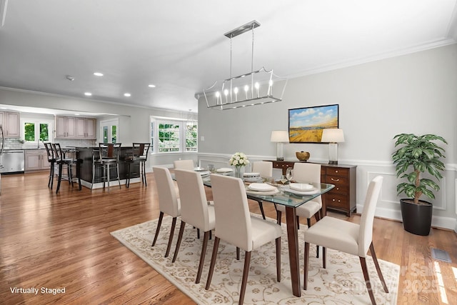 315 Red Barn Trl, Matthews, NC 28104 - dining space featuring crown molding, a chandelier, recessed lighting, light wood-style floors, and a wainscoted wall