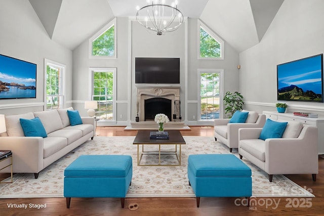 315 Red Barn Trl, Matthews, NC 28104 - living room featuring high vaulted ceiling, a chandelier, wood finished floors, and a high end fireplace