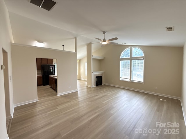 1423 Napa St NW, Concord, NC 28027 - unfurnished living room with ceiling fan, light wood-style flooring, a fireplace, vaulted ceiling, and baseboards