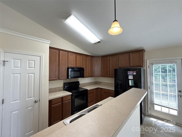 1423 Napa St NW, Concord, NC 28027 - kitchen featuring black appliances, vaulted ceiling, a sink, hanging light fixtures, and light countertops
