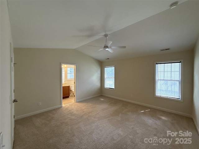 1423 Napa St NW, Concord, NC 28027 - unfurnished bedroom featuring baseboards, light carpet, lofted ceiling, ensuite bath, and ceiling fan