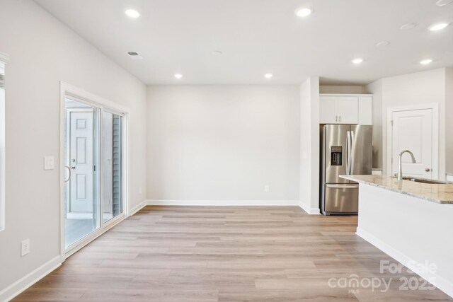 1413 Old Rivers Rd, Concord, NC 28027 - kitchen featuring stainless steel fridge, a sink, recessed lighting, light wood-style floors, and white cabinets