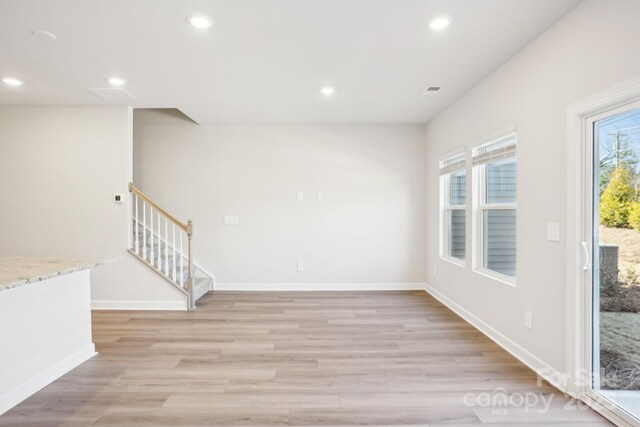 1413 Old Rivers Rd, Concord, NC 28027 - empty room with plenty of natural light, recessed lighting, light wood-style floors, stairway, and baseboards