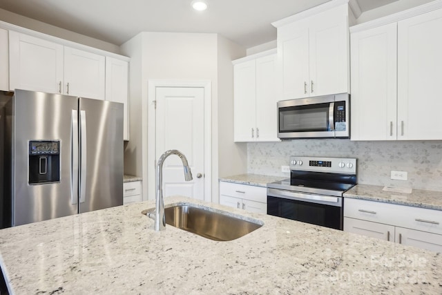1413 Old Rivers Rd, Concord, NC 28027 - kitchen featuring appliances with stainless steel finishes, a sink, white cabinetry, recessed lighting, and backsplash