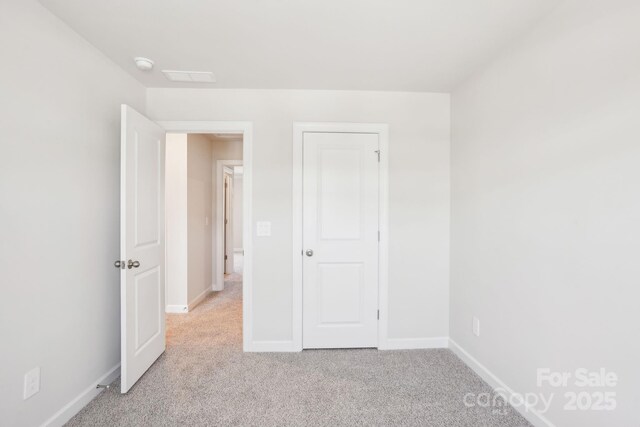 1413 Old Rivers Rd, Concord, NC 28027 - unfurnished bedroom featuring light colored carpet and baseboards