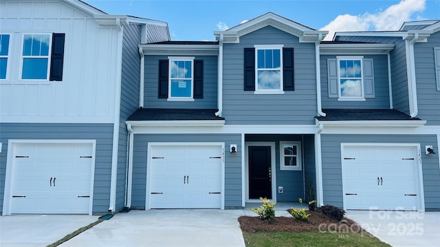 1413 Old Rivers Rd, Concord, NC 28027 - view of property featuring an attached garage, concrete driveway, and board and batten siding