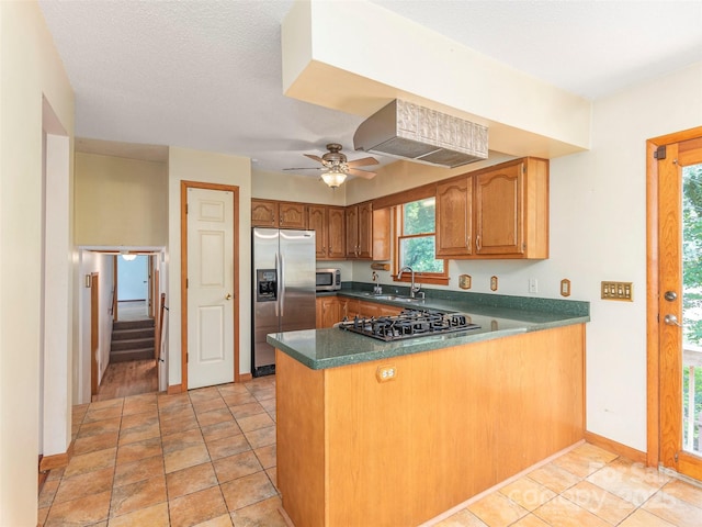 51 Wake Robin Way, Asheville, NC 28805 - kitchen featuring stainless steel appliances, a sink, a peninsula, brown cabinetry, and baseboards