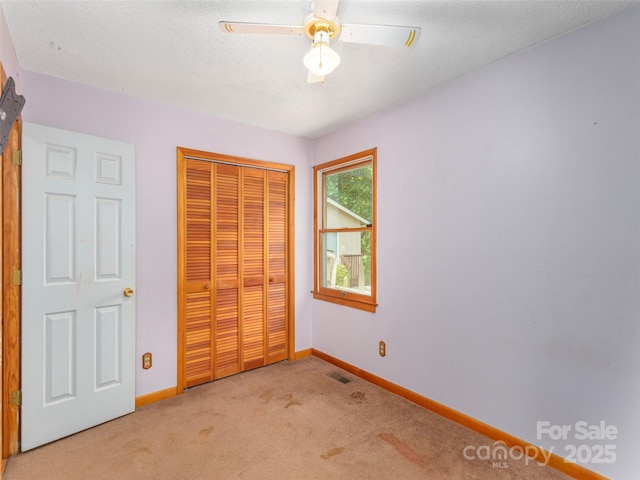 51 Wake Robin Way, Asheville, NC 28805 - unfurnished bedroom featuring light carpet, a closet, baseboards, a textured ceiling, and ceiling fan