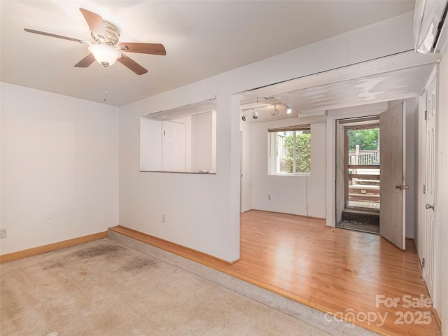 51 Wake Robin Way, Asheville, NC 28805 - unfurnished room with an AC wall unit, baseboards, and a ceiling fan