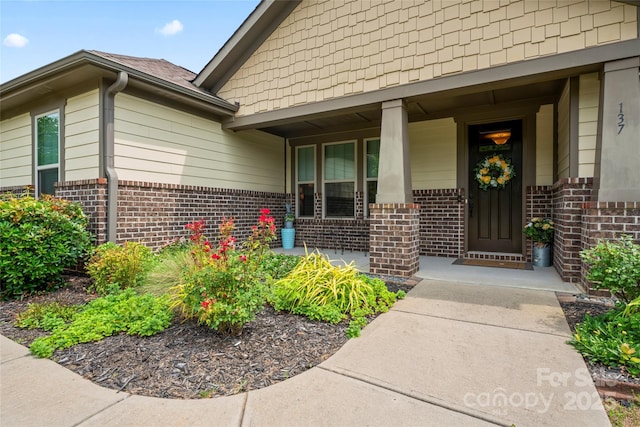 137 Leaning Tower Dr, Mooresville, NC 28117 - view of exterior entry featuring brick siding and covered porch