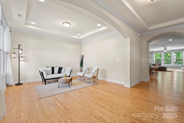 137 Leaning Tower Dr, Mooresville, NC 28117 - living area with a tray ceiling, arched walkways, wood finished floors, recessed lighting, and ornamental molding