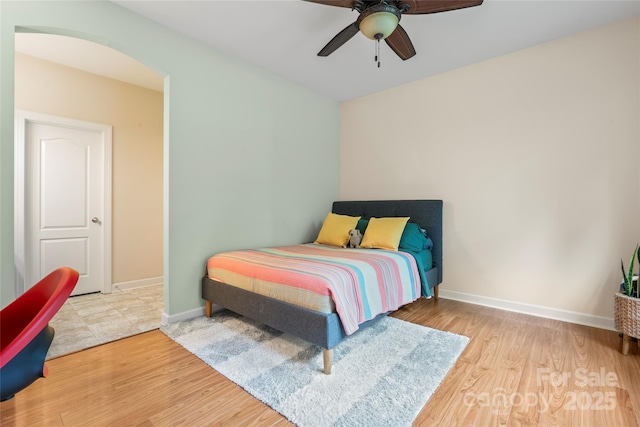 137 Leaning Tower Dr, Mooresville, NC 28117 - bedroom with wood finished floors, baseboards, arched walkways, and ceiling fan