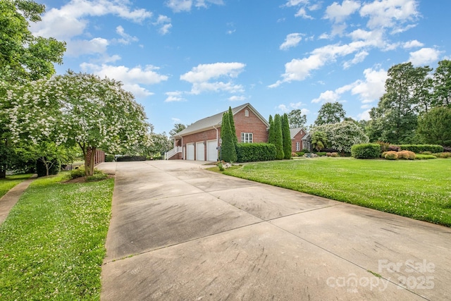 6823 Manatee Dr, Concord, NC 28025 - view of front of property with brick siding, driveway, a front yard, and a garage
