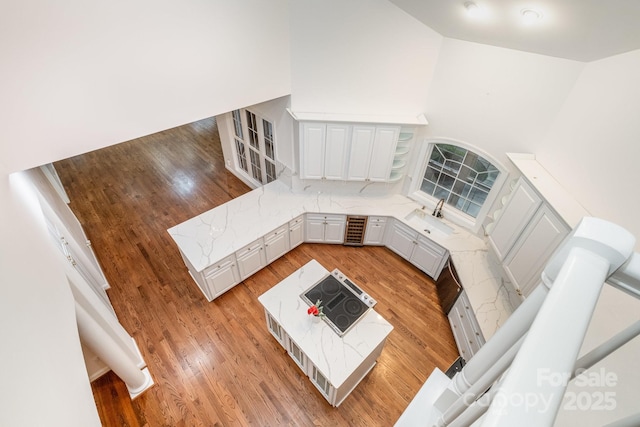 6823 Manatee Dr, Concord, NC 28025 - unfurnished living room featuring beverage cooler, a sink, and light wood finished floors