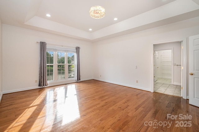 6823 Manatee Dr, Concord, NC 28025 - empty room with wood finished floors, recessed lighting, baseboards, and a raised ceiling