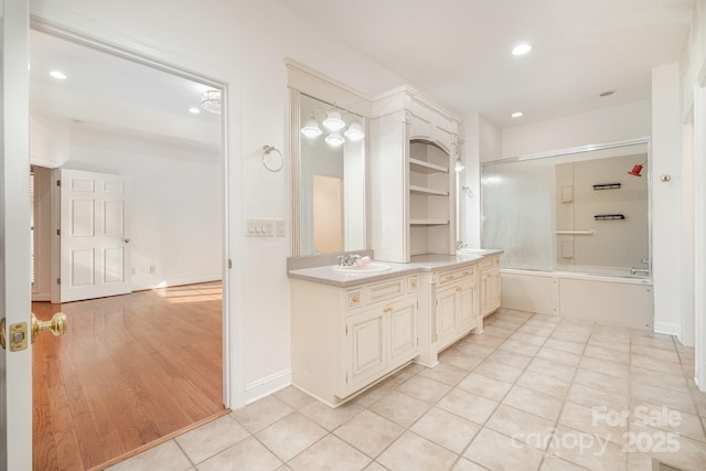 6823 Manatee Dr, Concord, NC 28025 - bathroom with double vanity, enclosed tub / shower combo, recessed lighting, and tile patterned flooring