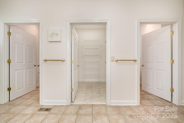 6823 Manatee Dr, Concord, NC 28025 - corridor featuring light tile patterned floors and baseboards