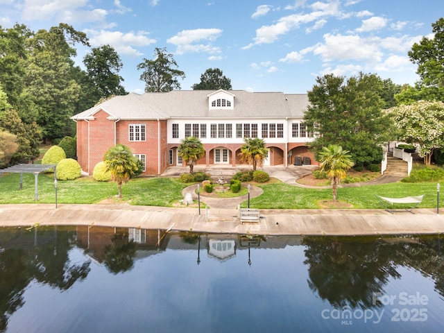 6823 Manatee Dr, Concord, NC 28025 - back of house featuring brick siding, a lawn, stairs, and a water view