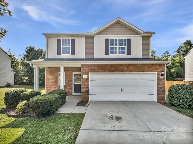 108 Greenway View Ct, Mount Holly, NC 28120 - view of front of home featuring stone siding, an attached garage, driveway, board and batten siding, and covered porch