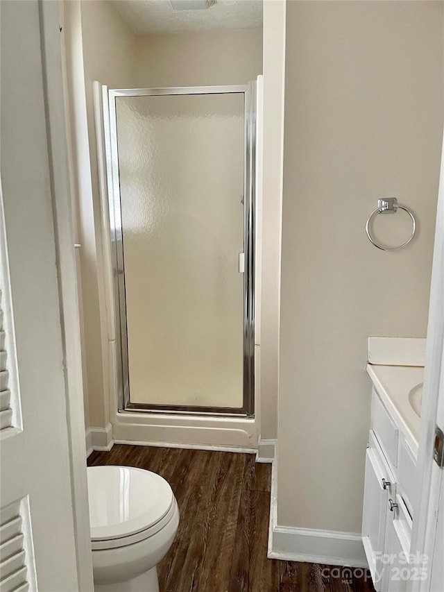 218 Hardin Cir, Grover, NC 28073 - bathroom featuring vanity, wood finished floors, a stall shower, and toilet