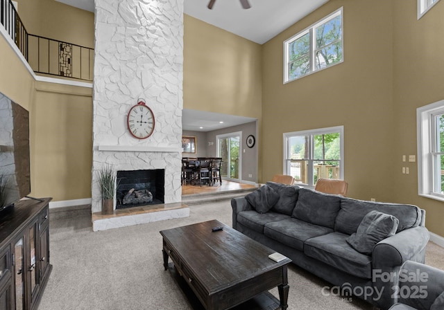 5075 Lakeview Cir, Sherrills Ford, NC 28673 - living area with a fireplace, carpet flooring, a high ceiling, plenty of natural light, and baseboards