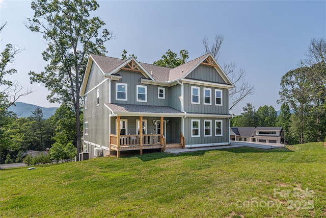 17 Baxter Woods Ln, Candler, NC 28715 - back of property featuring a porch, a yard, and a shingled roof