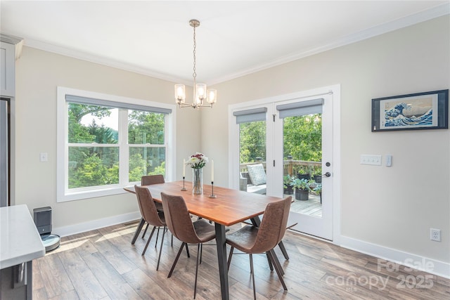 17 Baxter Woods Ln, Candler, NC 28715 - dining room featuring crown molding, a chandelier, healthy amount of natural light, and light wood-type flooring