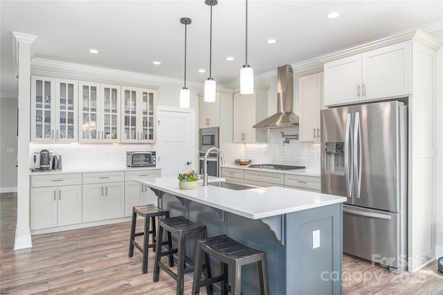 17 Baxter Woods Ln, Candler, NC 28715 - kitchen featuring stainless steel appliances, wall chimney range hood, backsplash, crown molding, and light countertops