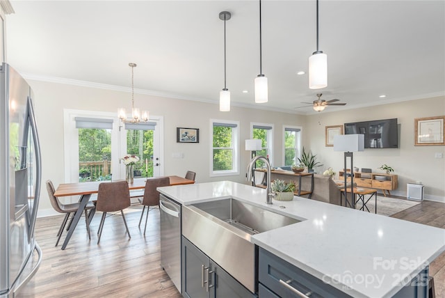 17 Baxter Woods Ln, Candler, NC 28715 - kitchen with appliances with stainless steel finishes, plenty of natural light, light wood-type flooring, ornamental molding, and recessed lighting