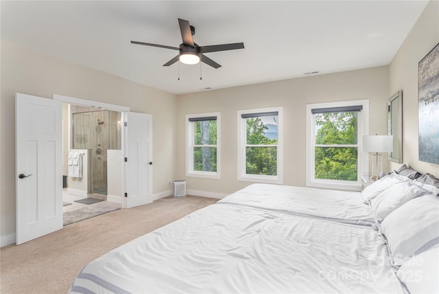 17 Baxter Woods Ln, Candler, NC 28715 - carpeted bedroom featuring multiple windows, ensuite bath, and ceiling fan