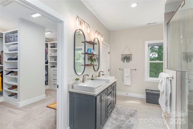 17 Baxter Woods Ln, Candler, NC 28715 - full bathroom with double vanity, a walk in closet, a shower with door, and recessed lighting