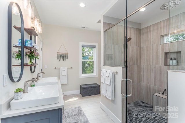 17 Baxter Woods Ln, Candler, NC 28715 - full bathroom featuring a tile shower, double vanity, recessed lighting, and wood finished floors