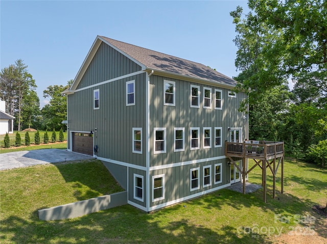 17 Baxter Woods Ln, Candler, NC 28715 - rear view of house featuring a garage, driveway, a deck, and a yard