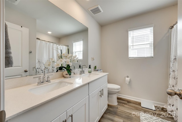 322 Olympia Way, York, SC 29745 - bathroom featuring toilet, double vanity, wood finished floors, baseboards, and recessed lighting