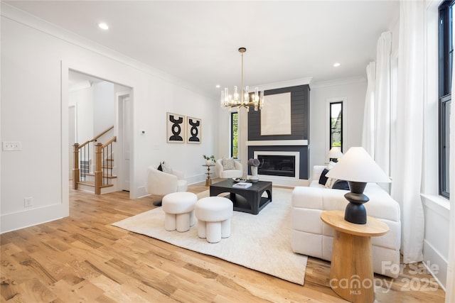 3903 Plainview Rd, Charlotte, NC 28208 - living room with light wood-style floors, a chandelier, crown molding, stairway, and a fireplace