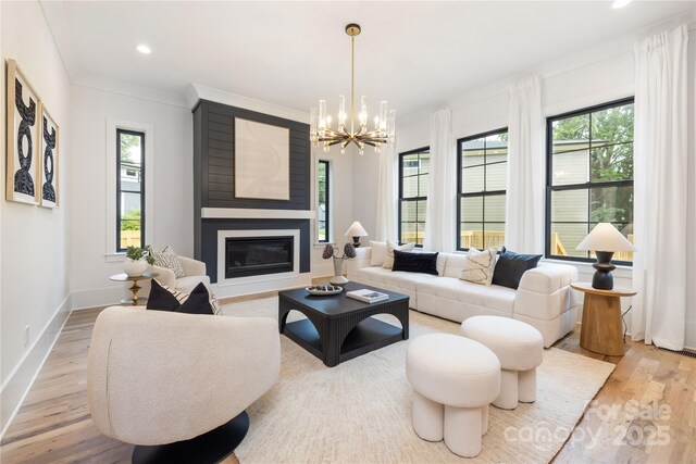 3903 Plainview Rd, Charlotte, NC 28208 - living area with a fireplace, plenty of natural light, a chandelier, wood finished floors, and recessed lighting