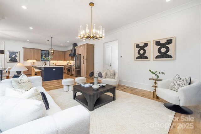 3903 Plainview Rd, Charlotte, NC 28208 - living room with a chandelier, light wood-style floors, crown molding, recessed lighting, and baseboards