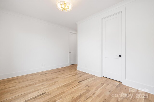 3903 Plainview Rd, Charlotte, NC 28208 - unfurnished bedroom with crown molding, light wood-style floors, a chandelier, and baseboards